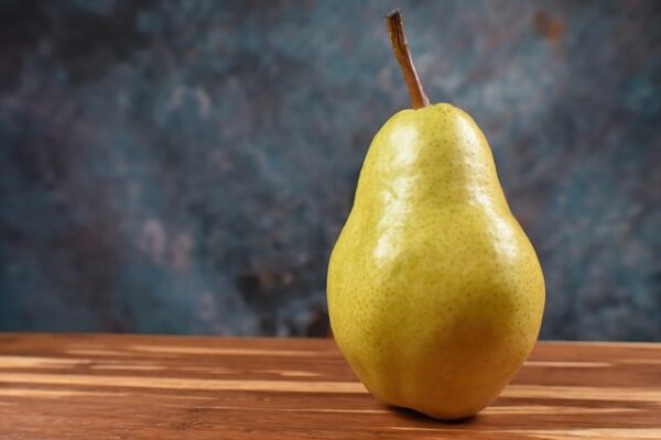 A large yellow pear with slight pink blush