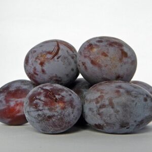 A stack of reddish/purple plums