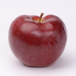 Glossy red apple with white specks